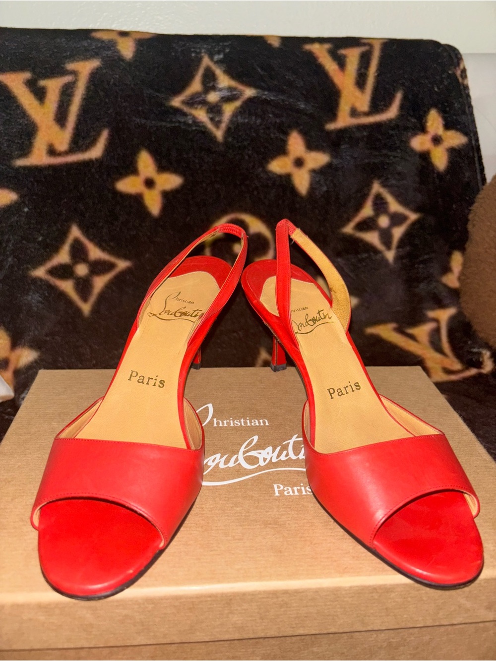 Christian Louboutin orange red tone leather slingback heels .